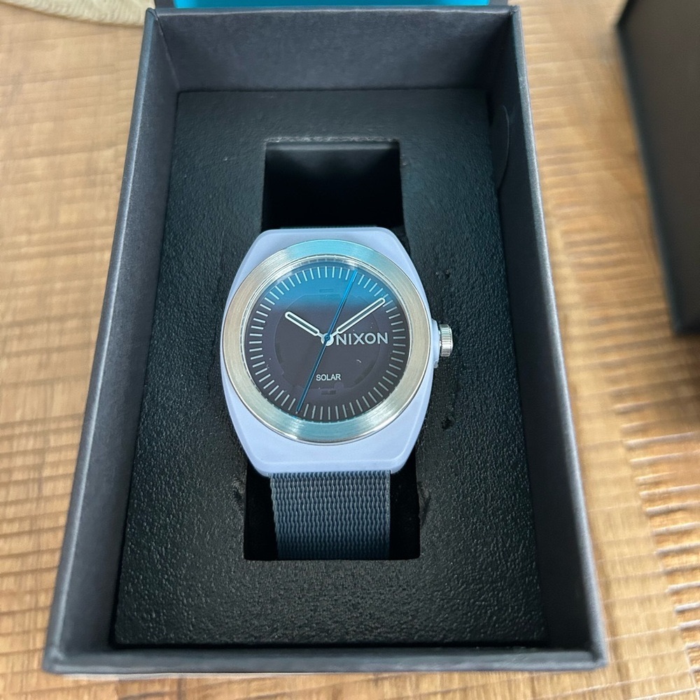 Nixon light gray solar watch. Never buy another watch battery again.
